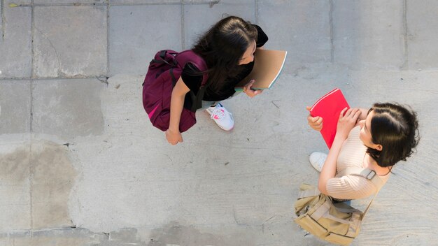 top aerial view teen girls talk and meet at pedestrian walk way