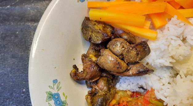 Top angle, fried chicken liver with chili sauce and boiled carrots as a side dish 01