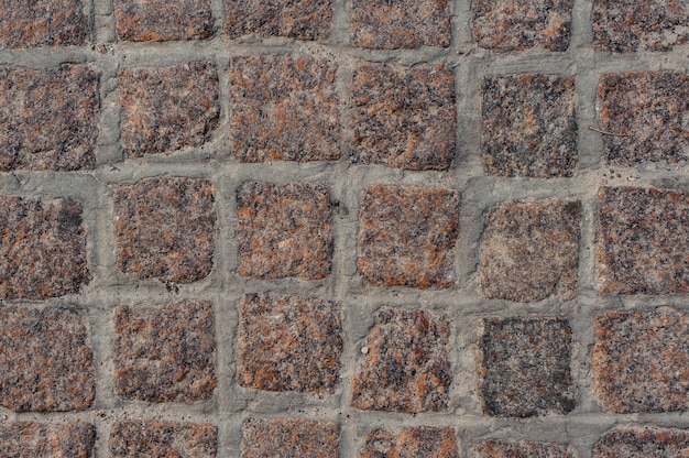 Top background macro photography of brown stone block road pavement