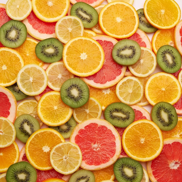 Фото Вид сверху вниз на задний план из свежих нарезанных органических апельсинов киви и лимонов крупным планом