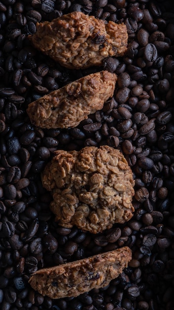 Top down flat lay view of four oatmeal cookies on coffee beans