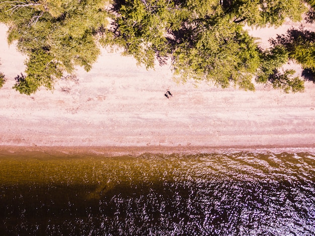 Top down two man chill on summer tropical beach aerial view