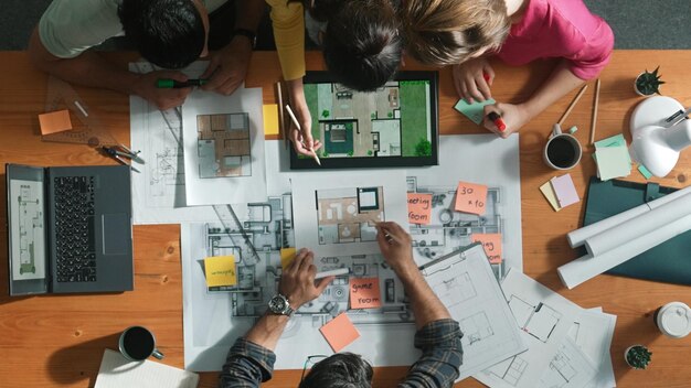 Photo top down view of civil engineer planning and writing at blueprint symposium