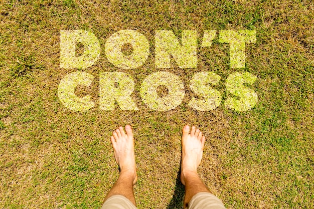 Photo top down view of legs feet standing on the ground with don't cross text concepts