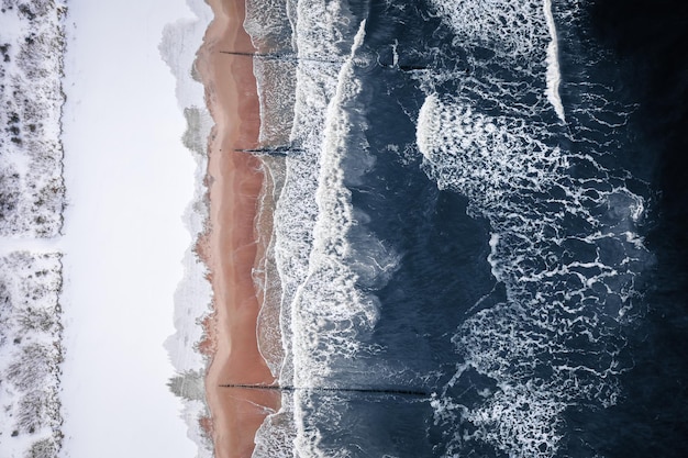 Top down view of winter Baltic sea and snowy beach