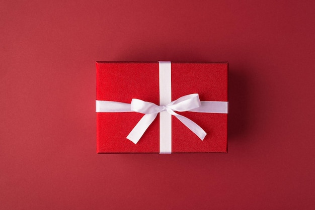 Top flat lay close up view photo of beautiful present box isolated luxurious red background