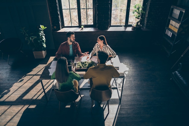 Photo top above high angle view  of focused group people entrepreneur discus start up progress planning experience project sit table