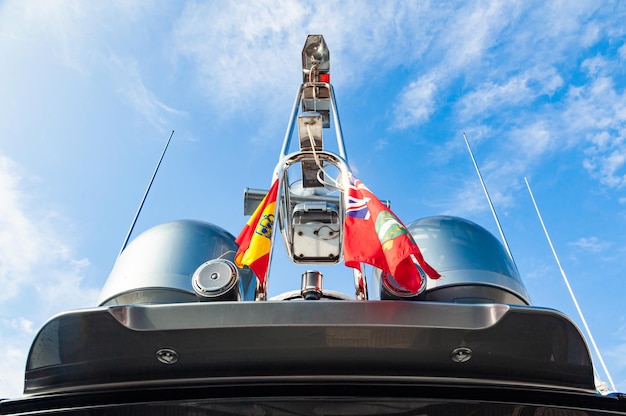 The top of a modern yacht with satellite equipment navigation radars and signal lights on the mast