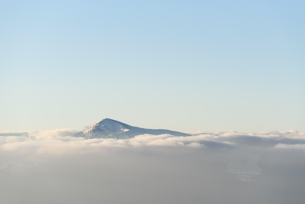 Top of Mount Hoverla in the Ukrainian mountains Carpathians with morning fog in the valley