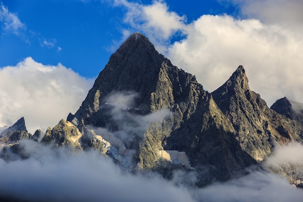 Top of the mountain with glacier, in the clouds