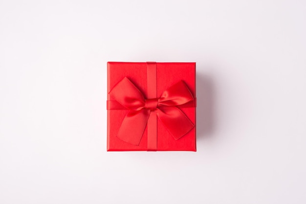 Top above overhead close up view photo of small present red bright box isolated over white color background