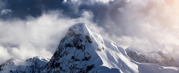 Top of peak in canadian mountain landscape covered in clouds aerial view near vancouver bc canada