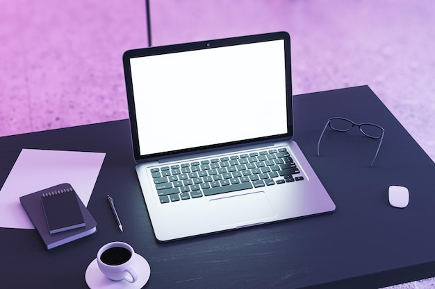 Top perspective view on blank white modern laptop screen with place for web design or landing page on dark work table with coffee cup and office tools on purple wall background 3D rendering mockup