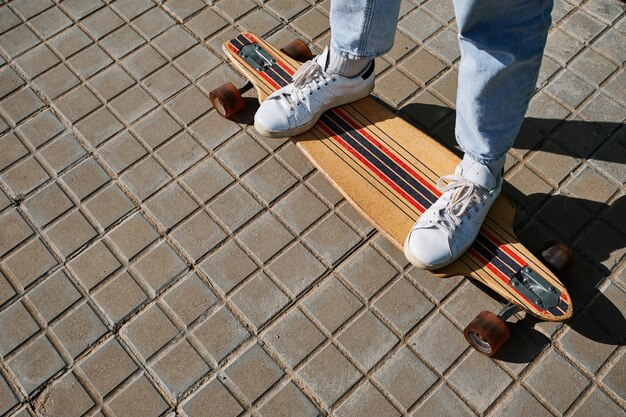 top photo of an skate and feet of a young skater on top of it