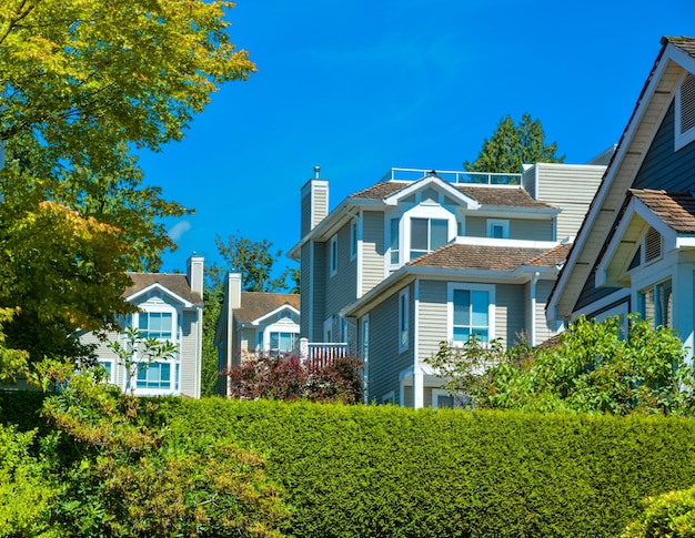 Top of residential townhouses on blue sky background