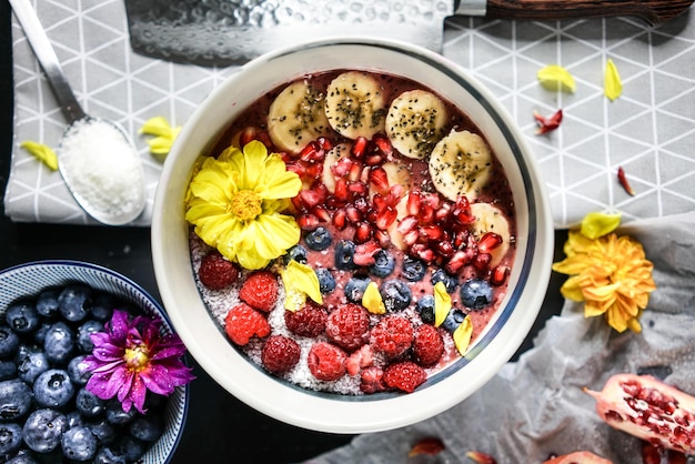 Top shot van een fruitcake met bessen, banaan en granaatappel. Bakproces in de keuken