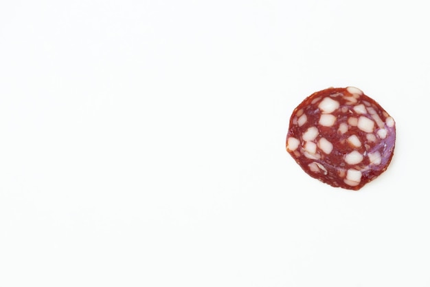 Top and side views of smoked salami sausage slices isolated on white background