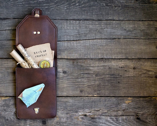 top travel wooden background, bag, map