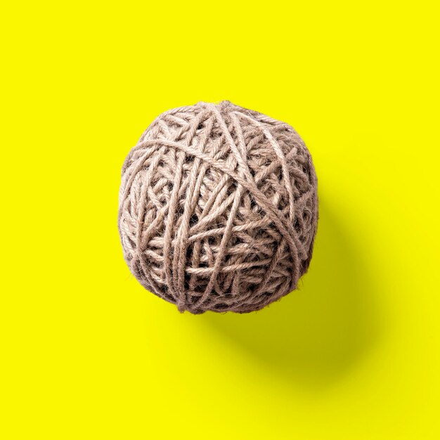 Top up view jute ball isolated on yellow