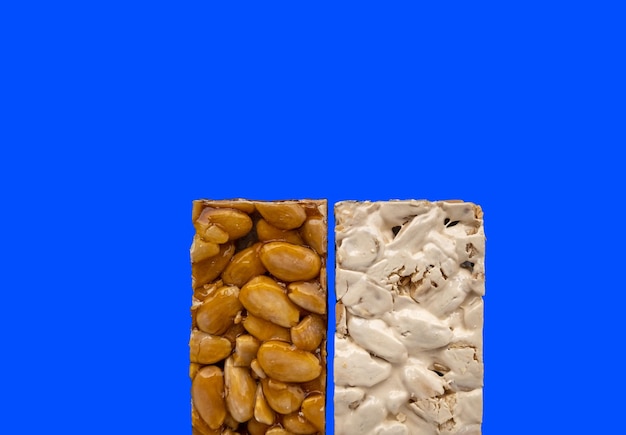 Top view of 2 different types of Spanish Turrons on blue background