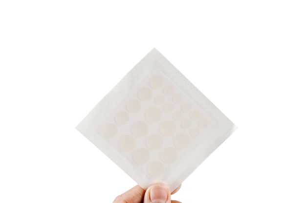 Top view of acne patch for facial rejuvenation Set of round patches for acne in hand on white background Facial cleansing cosmetology