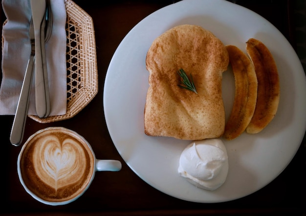 Top view of afternoon coffee with butter toast cream