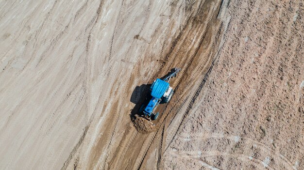 Top view of agricultural tractor vehicles working at field