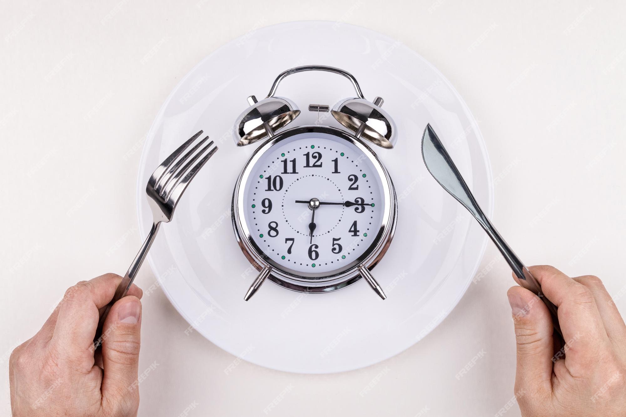 top view alarm clock white plate with knife fork white background intermittent fasting ketogenic diet weight loss meal plan healthy eating concept 739531 66