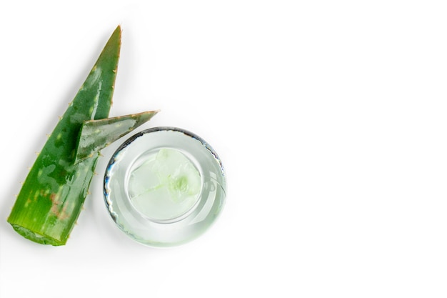 Top view on a aloe vera. Aloe vera gel in a glass jar on a white background