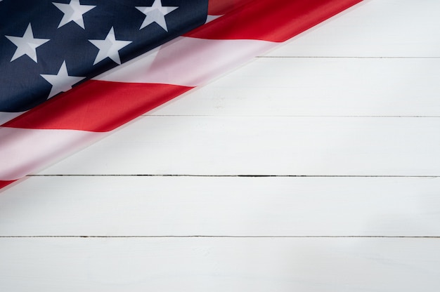 Top view of American flag on white wood