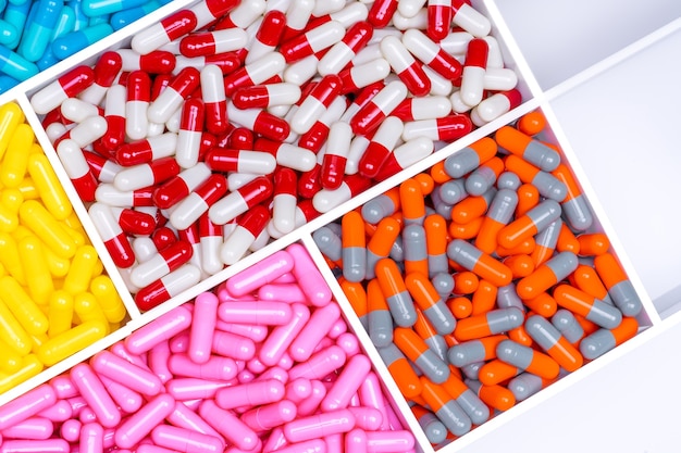 Top view of antibiotic capsule pills in plastic drug tray