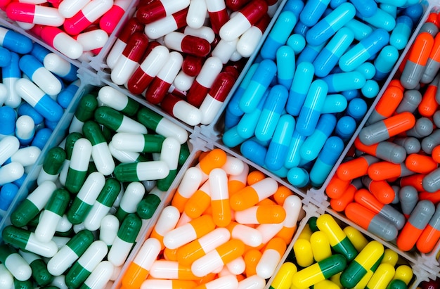 Top view of antibiotic capsule pills in plastic tray.