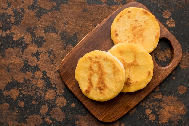 Top view arepas on wooden board