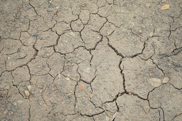 The top view arid soil on the ground is dried and broken in some place of Thailand
