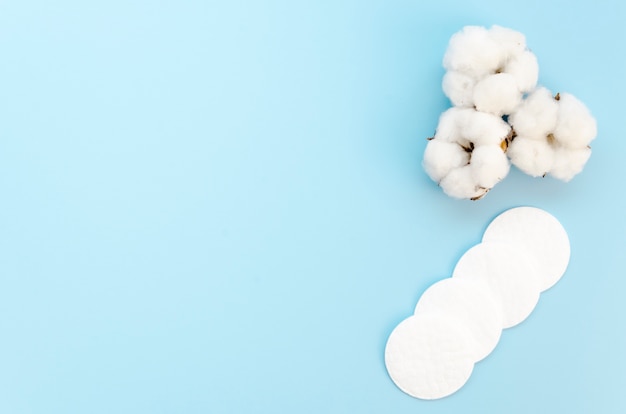 Top view arrangement with cotton pads on blue background