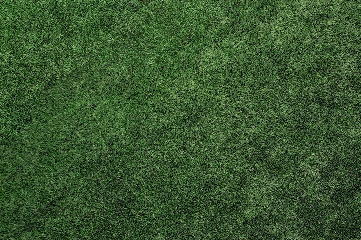 Photo top view of artificial grass, texture of green artificial lawn.
