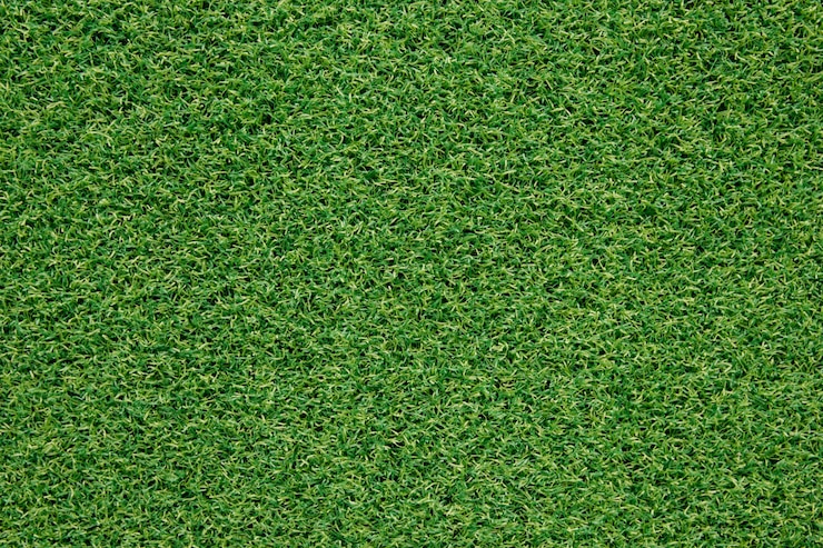 Photo top view artificial green grass texture for background