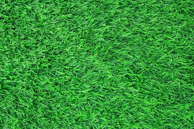 Top view of artificial green grass texture background.