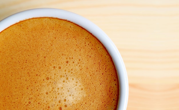 Top view of artistic texture of frothy hot coffee surface