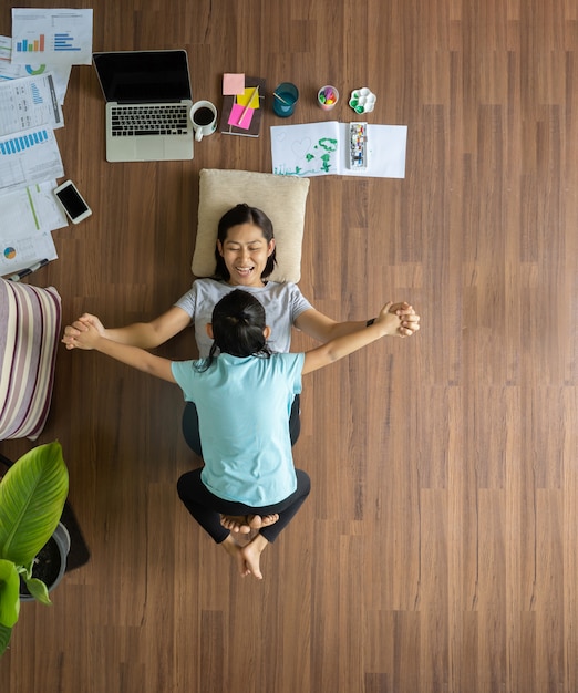 Top view asian woman with children playing at house on wooden floor