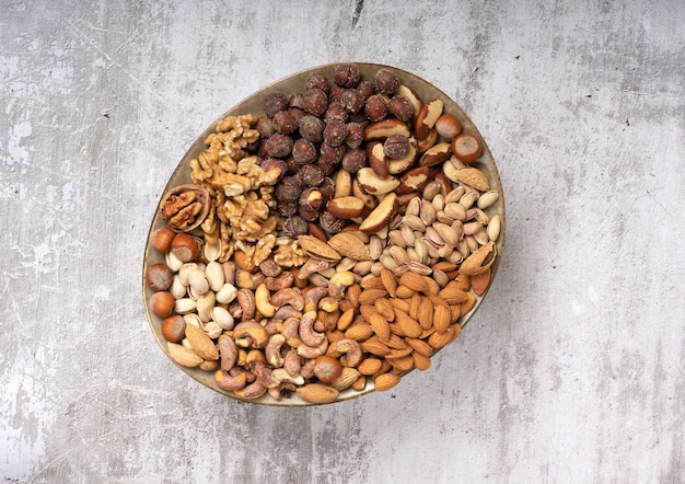 Top view of assorted different types of nuts on a plate.