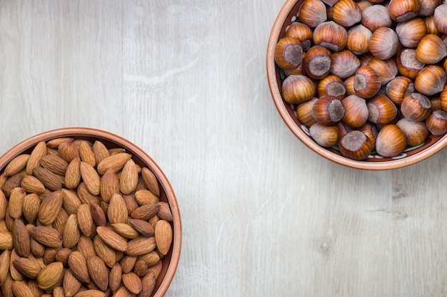 Top view on assorted nuts on wooden background. Copy space.