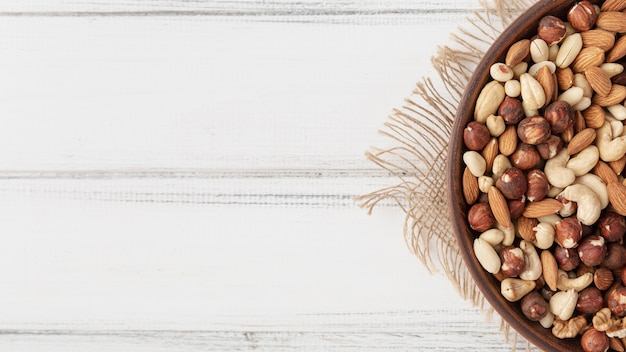 Top view of assortment of nuts in bowl with almonds