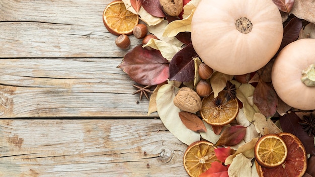 Top view of autumn leaves with dried citrus and squash