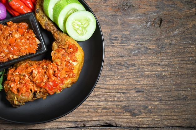 Top view ayam geprek indonesian food or geprek fried chicken with hot chili sauce served rice