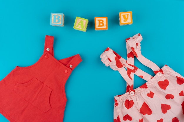 Top view of baby clothes on blue background