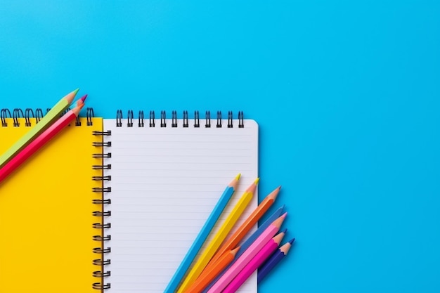 Top view of back to school stationery with colorful pencils and notebooks