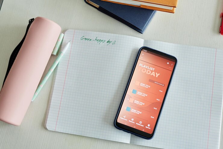 Photo top view background of notebook and smartphone on childs desk in school classroom copy space