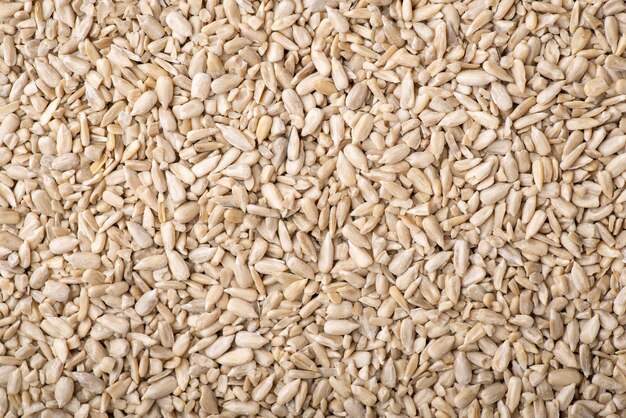 Top view background of peeled sunflower seeds