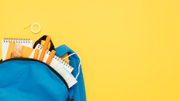 Top view backpack with school supplies